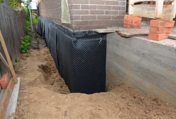 Happy homeowners after waterproofing job in Malcolm